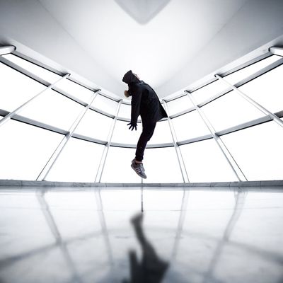 Dynamic silhouette of a person in mid-motion against a window.